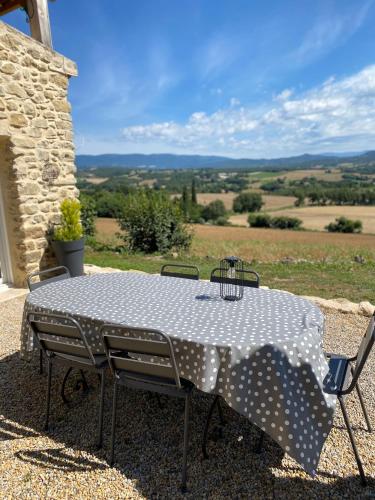 a table and chairs with a view of a field at La Magnanerie en Provence in Niozelles