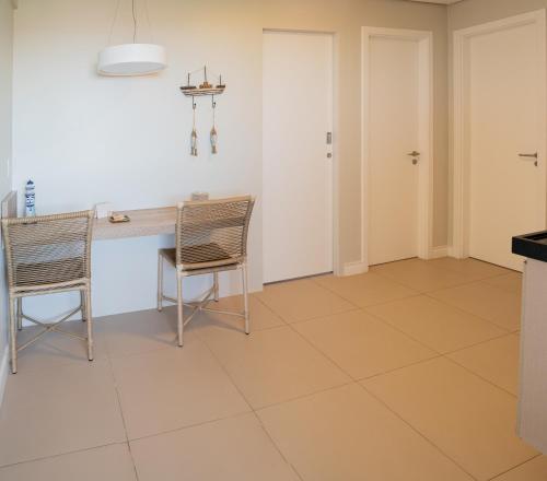 a kitchen with a table and two chairs at Porto das Dunas Boutique Praia Hotel in Aquiraz