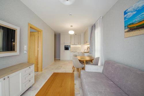 a living room with a couch and a table at Apartamenty Akwamaryn in Ustka