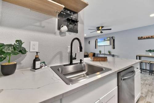 a kitchen with a sink and a counter at Stay Awhile Condo Minutes to Beach with Pool in Galveston