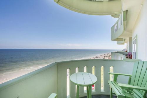 a balcony with a table and chairs and the ocean at Oceanside Escape with 3 Bedrooms Spectacular Ocean View and Pool in Galveston