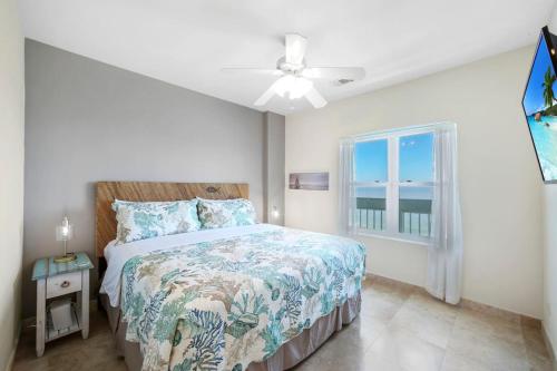 a bedroom with a bed and a window at Oceanside Escape with 3 Bedrooms Spectacular Ocean View and Pool in Galveston