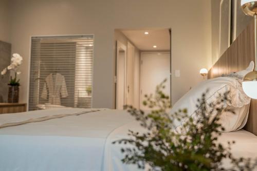 a bedroom with a bed and a large mirror at Blue Tree Premium São Luis in São Luís