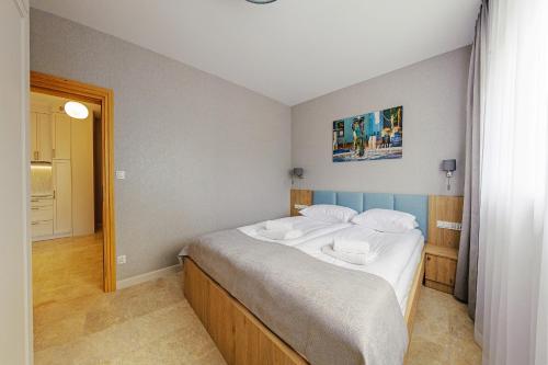 a bedroom with a bed with two towels on it at Apartamenty Akwamaryn in Ustka