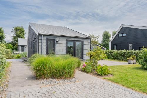 a gray house with a gray roof at Beau Su Mer nr 1 in Kattendijke
