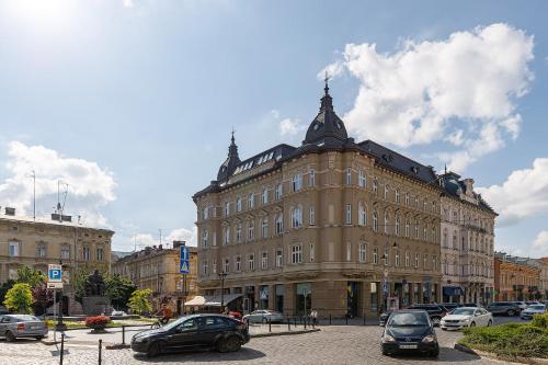 a large building with cars parked in front of it at Modern Art Hotel in Lviv