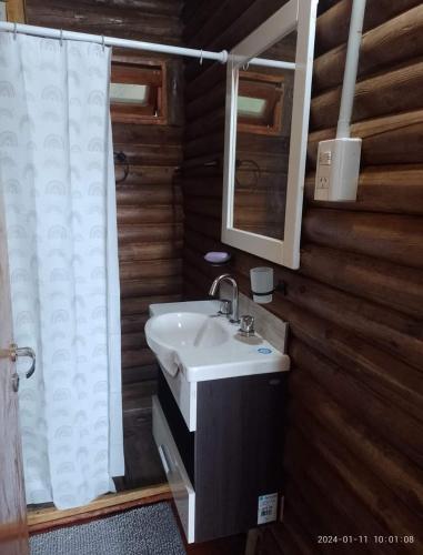 a bathroom with a sink and a mirror at Amphu mariposa in La Falda