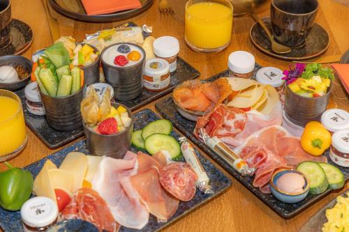 a table with many different types of food and drinks at La Mansion Vi Vadi Hotel in Munich