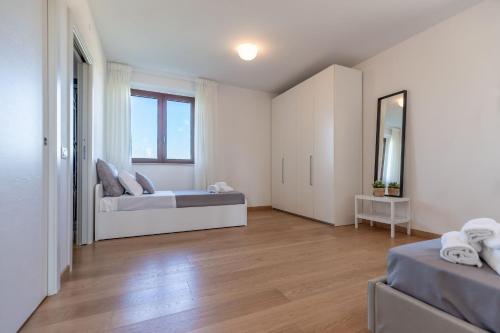 a large room with two beds and a mirror at Italian Experience-Villa Clair in Fermo