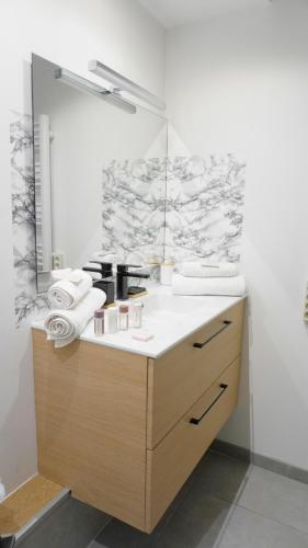 une salle de bain avec un lavabo et un miroir dans l'établissement Appartement 426, vue mer et piscine by Palmazur, à Cannes