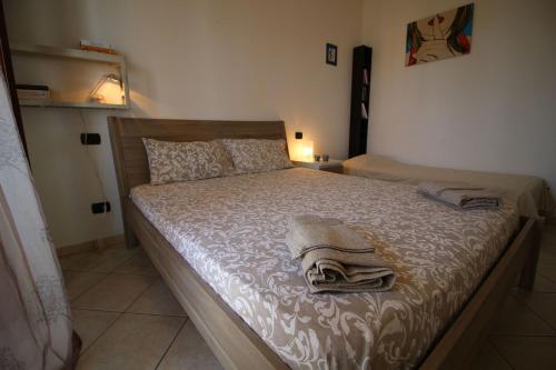 a bedroom with a bed with two towels on it at Italian Experience-Bellaria Suite Apartment in Bellaria-Igea Marina