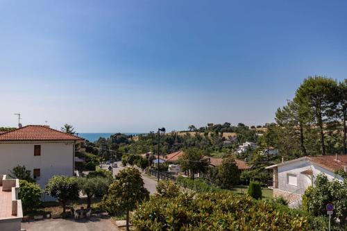 a view of a town with the ocean in the background at Italian Experience-Numana Suite Apartment in Numana