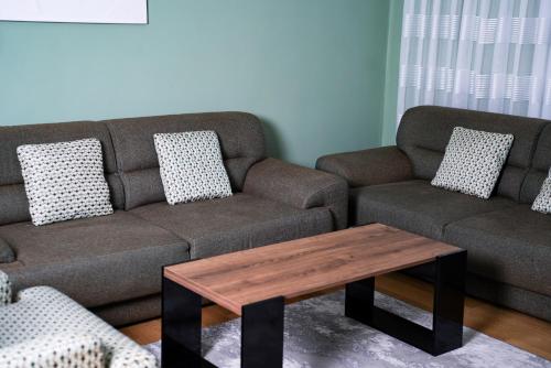 a living room with a couch and a coffee table at Prishtina Getaway Apartment in Pristina