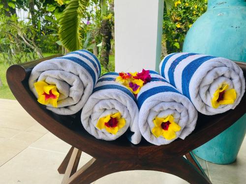 a bunch of towels with flowers in them at Villa Saffraan Bali in Banjar