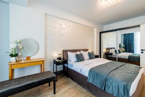 a bedroom with two beds and a mirror at Miramar - Alezzi Infinity Beach Resort in Năvodari