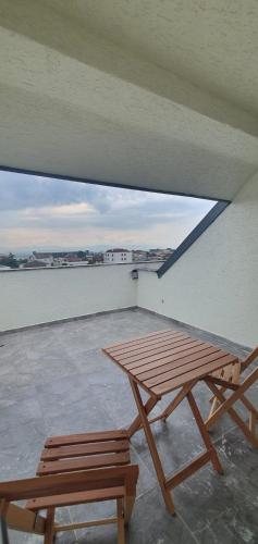 a picnic table and two benches on a roof at Petra Port Hotel in Tuzla