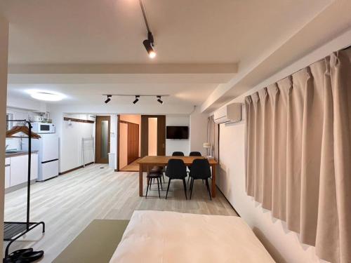 a dining room and kitchen with a table and chairs at 上野東京セントラルステイ 山手線駅徒歩3分御徒町 大人数 アメ横3分 上野駅10分 湯島駅2分 in Tokyo
