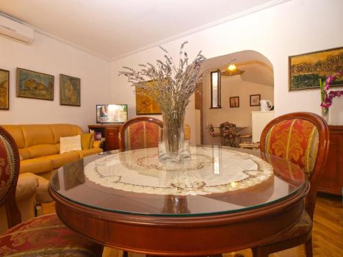 a living room with a table with a vase of flowers on it at Ferienhaus für 4 Personen ca 75 qm in Pula, Istrien Istrische Riviera in Pula