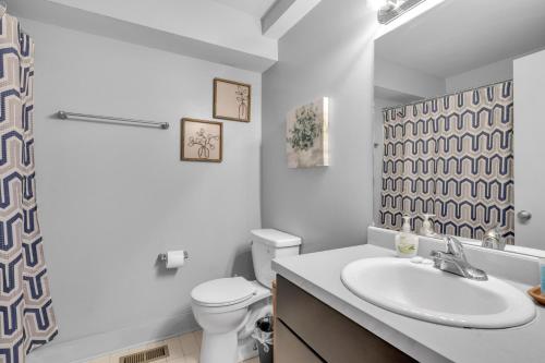 a white bathroom with a sink and a toilet at The Lofts of Downtown (540 N 2nd St, #208) in Clarksville