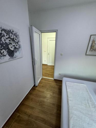 an empty room with a bed and a hallway at Villagio in Virpazar