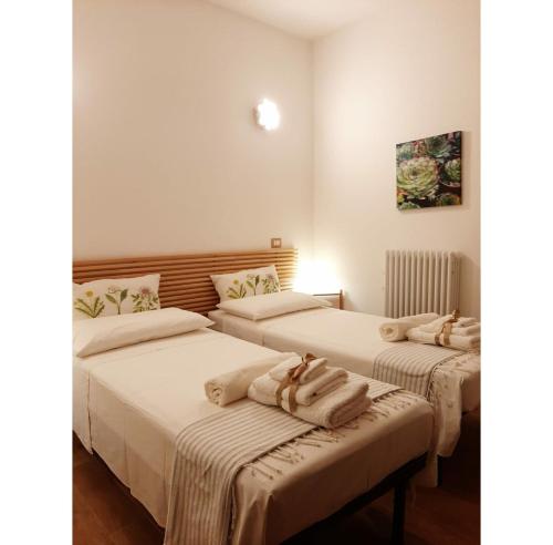 a room with two beds with towels on them at Italian Experience-La Casa di Campagna in Molino di Carassai
