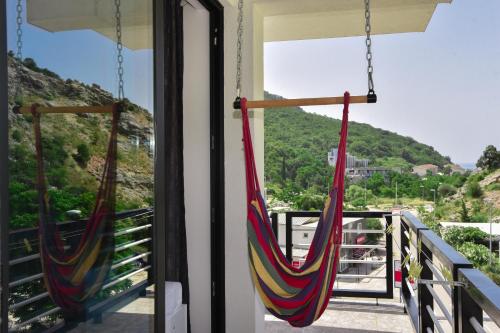 a pair of hammocks hanging from a balcony at Apartments A Čanj in Čanj
