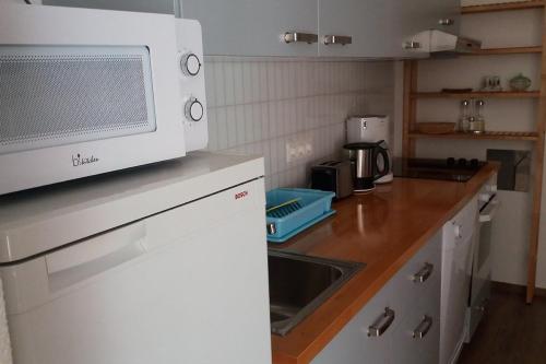 a kitchen with a microwave on top of a counter at Apartment Letica 2 in Malinska