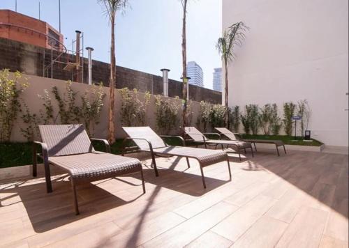 a row of chairs sitting on a patio at Chácara Santo Antonio ao lado da Estação João Dias in Sao Paulo