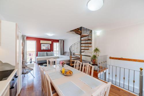 a kitchen and living room with a table and chairs at Liston Suites in Corfu Town