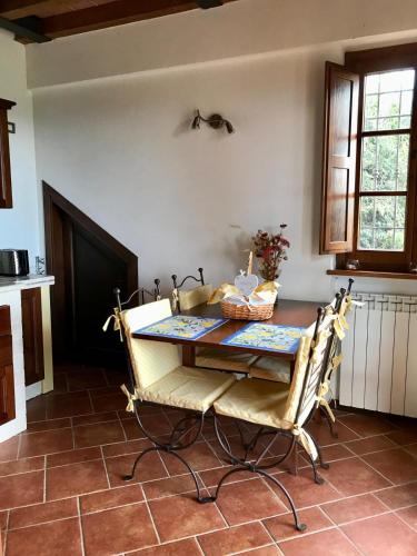 a kitchen with a table and chairs in a room at Villa Panorama in Montecatini Val di Cecina