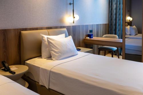 a hotel room with a bed and a table at Delta Hotels by Marriott Antalya Lara - Adult Only 18 Plus in Antalya