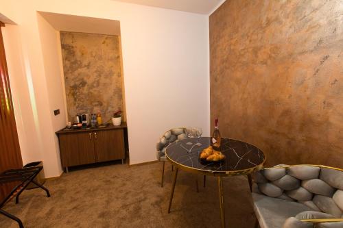 a living room with a table and a couch at Al Centro in Bucharest