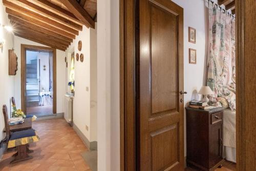 a hallway with a wooden door in a room at Italian Experience-Il Borgo Apartment in Bientina