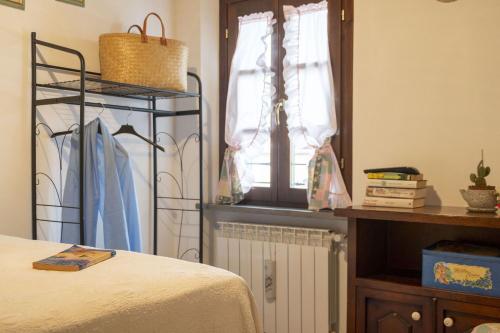 a bedroom with a bed and a window and a shelf at Italian Experience-Il Borgo Apartment in Bientina