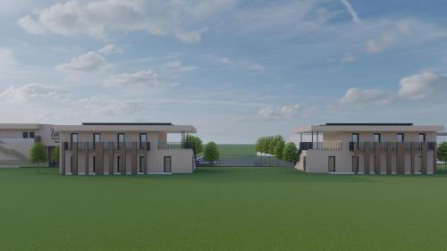a rendering of two buildings in a green field at Monteurzimmer - SIDO Immobilien in Neupirka