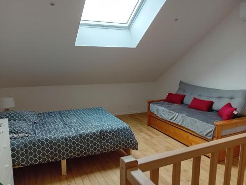 a bedroom with two beds and a window at Maison du Potager de Puy Marot in Feytiat