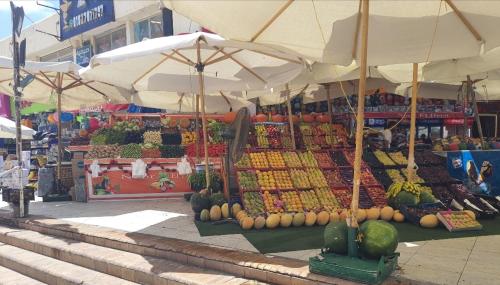 an outdoor market with fruits and vegetables on display at Chalet 3 bedrooms 2 toilets lotus north cost stand alone 3 Ac 2 stand fan families are preferred in El Alamein
