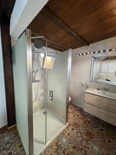 a bathroom with a glass shower and a sink at Hospedería Almundo by Alexandra Realty in Tarifa