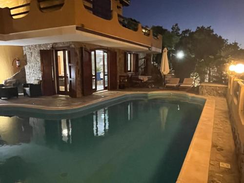 The swimming pool at or close to VILLA VITTORIA with PRIVATE HEATED SWIMMING POOL COMPLETE WITH HIDROMASSAGE FOR EXCLUSIVE USE , SEA VIEW, 150 METERS FROM THE BEACH