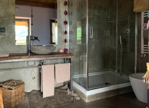 a bathroom with a shower and a sink and a tub at Affittacamere Montagne Verdi in Varallo