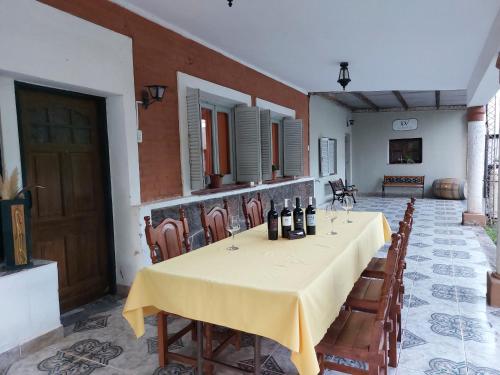 un comedor con una mesa con botellas de vino. en Bodega y Alojamiento Don Vega 2, en Tinogasta