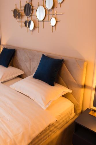 a bed with a bunch of pots and pans on the wall at Al Centro in Bucharest