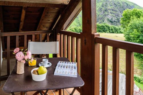 a table with a keyboard and a computer on a balcony at Logis Hôtel Etchemaïté in Larrau