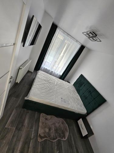 a small bedroom with a bed and a window at Filip residence in Cluj-Napoca