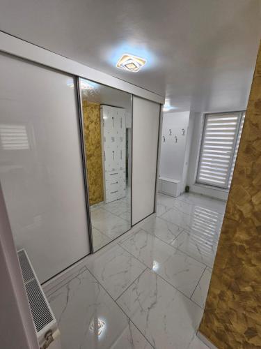 a room with a mirror and a tile floor at Filip residence in Cluj-Napoca