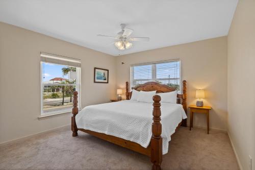 a bedroom with a bed and a window at Keepin' It Reel Beach House in Pensacola Beach