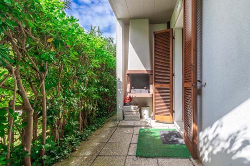 a cat is sitting outside of a house at Italian Experience-Conero Garden Apartment in Marcelli