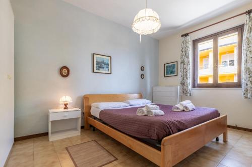 a bedroom with a bed with towels on it at Italian Experience-Conero Garden Apartment in Marcelli