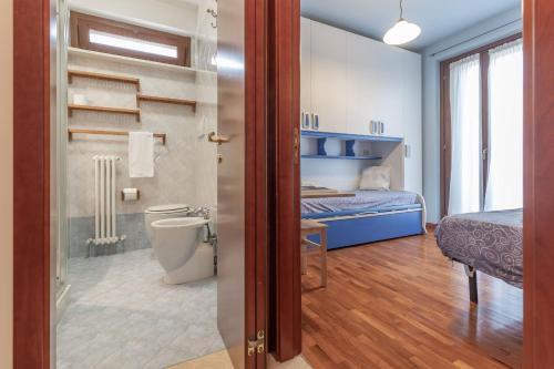 a bathroom with a bed and a toilet in a room at Italian Experience- Casale Al Mare in Loreto