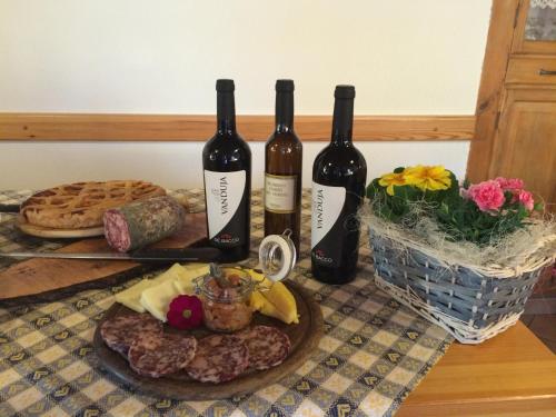 three bottles of wine sitting on top of a table at Rifugio Pranolz in Trichiana
